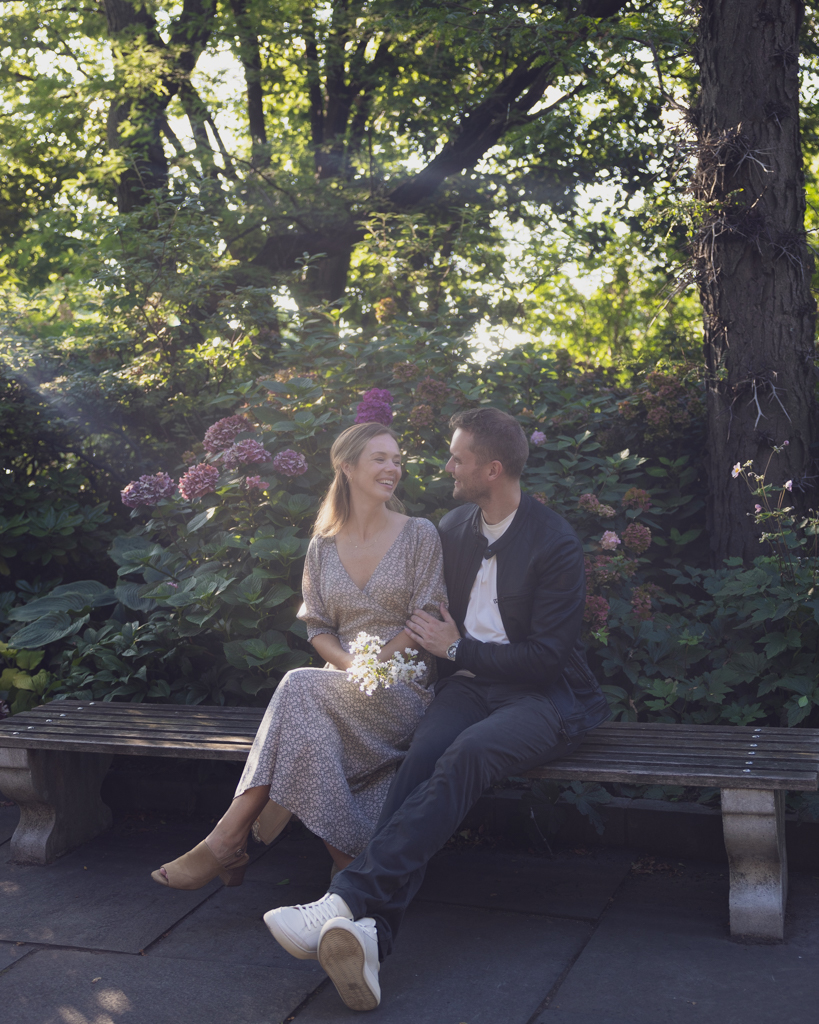 Emily and Liam couple pose on bench NYC Upper West Side Engagement shoot