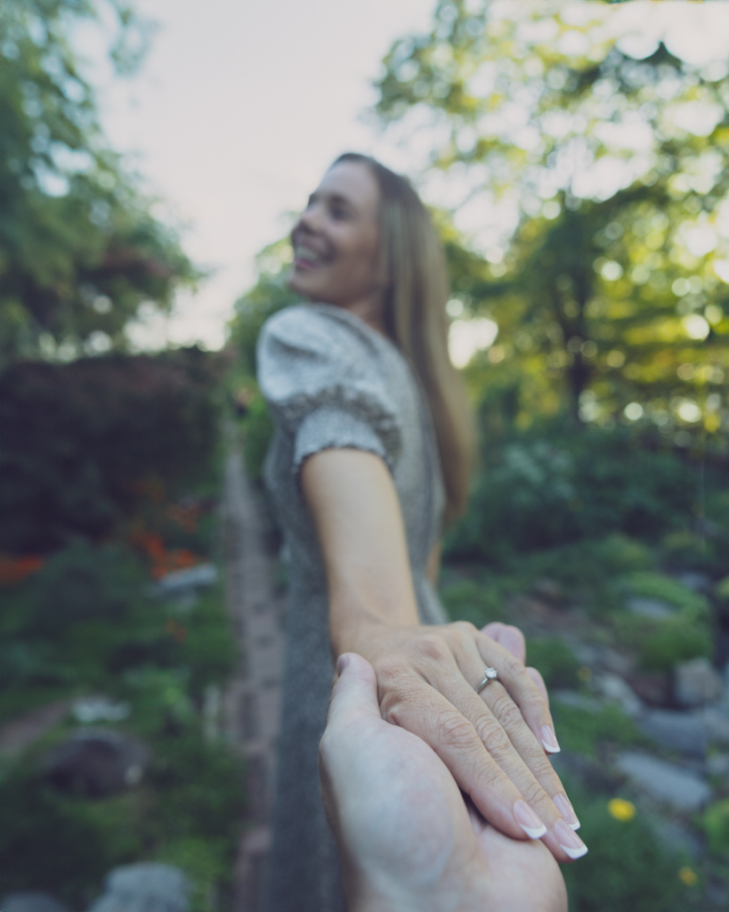 Emily and Liam NYC Upper West Side Engagement shoot walk through garden engagement ring