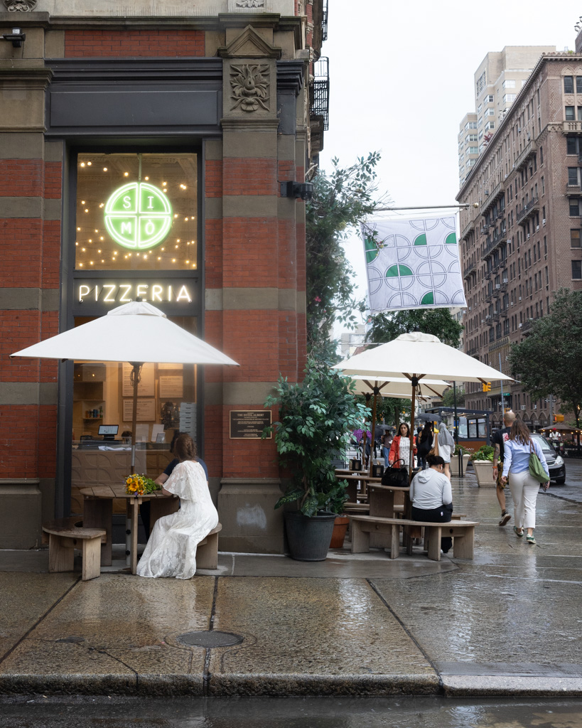 Manhattan couple session at a classic New York pizzeria, romantic candid moment