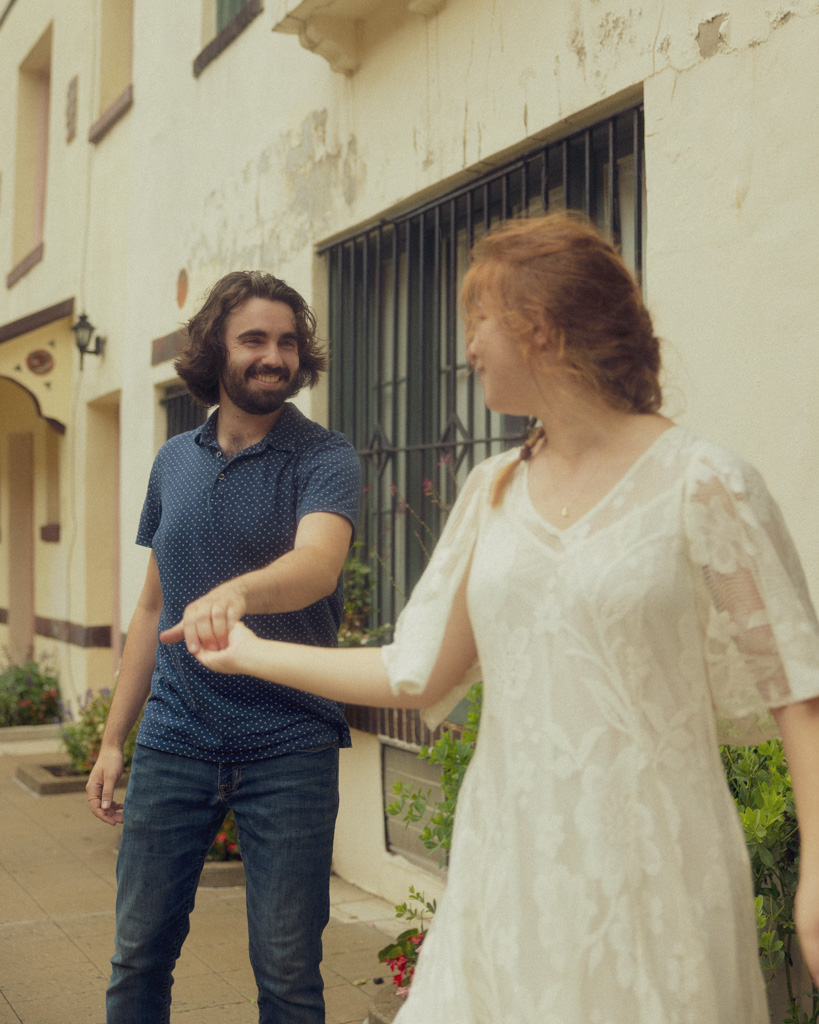 Couple enjoying a whimsical photoshoot, dancing together at Washington Mews, NYC
