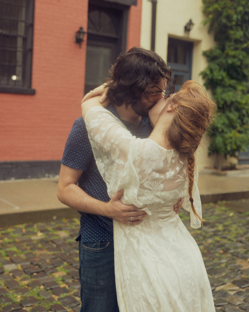 Intimate New York City couple photography of Lucy and Mark sharing a kiss at Washington Mews, Manhattan